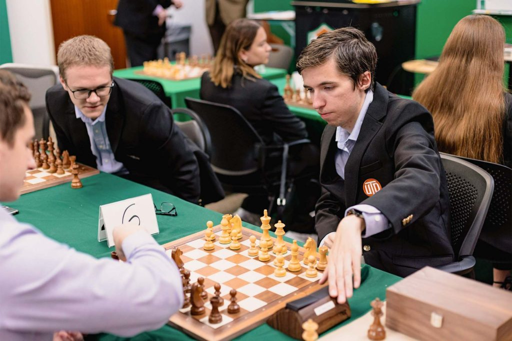 University of Texas at Dallas chess team members David Brodsky and Andrei Macovei practice as teammate Ivan Schitco watches.